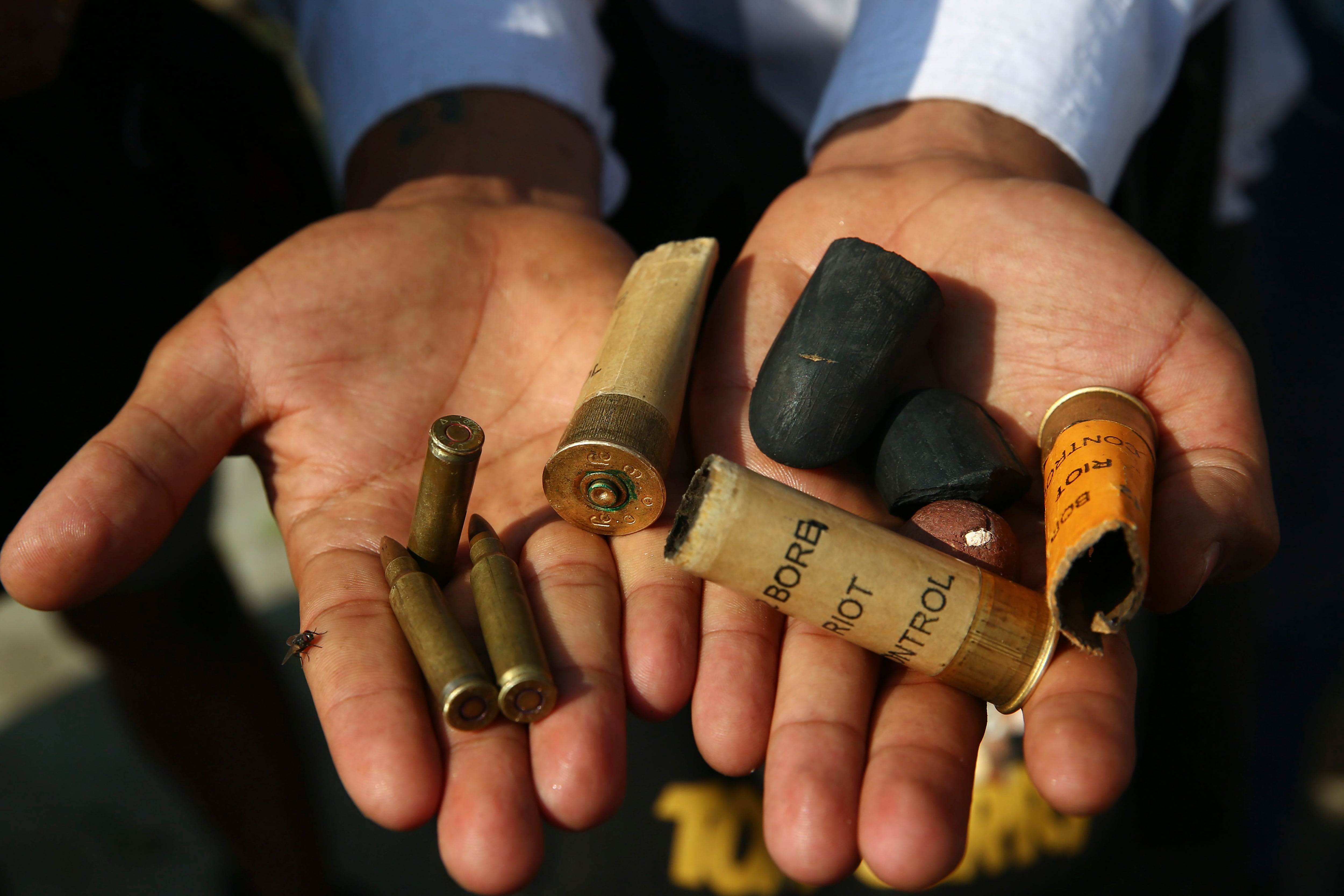 A protester show bullets, shotgun shells and rubber bullets used by security forces during a demonstration against the military coup in Mandalay, Myanmar, Friday, Feb. 26, 2021. In the month since Feb. 1 coup, the mass protests occurring each day are a sharp reminder of the long and bloody struggle for democracy in a country where the military ruled directly for more than five decades. (AP Photo)