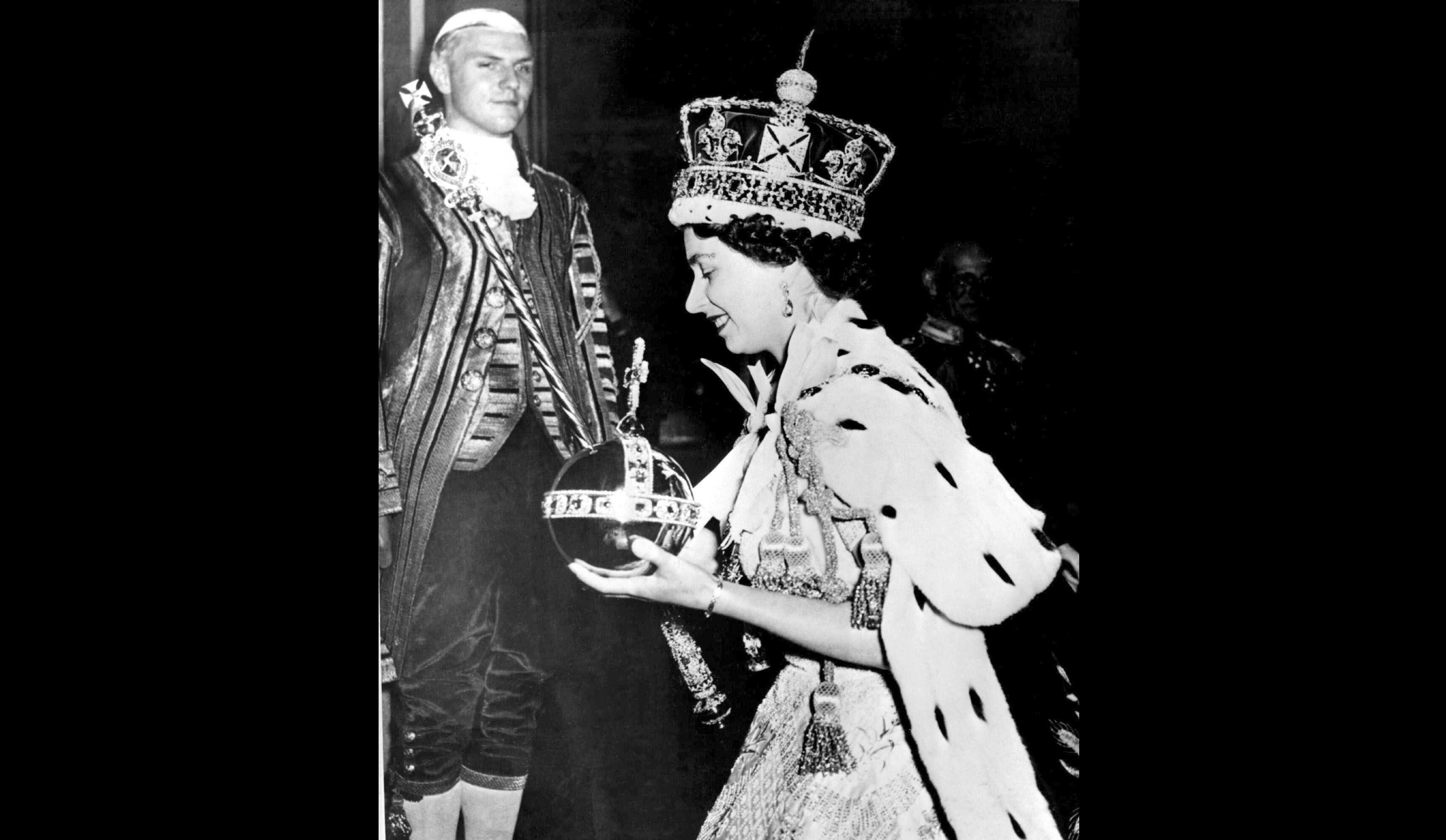 FILE - In this June 2, 1953 file photo, Britain's Queen Elizabeth II wearing the bejeweled Imperial Crown and carrying the Orb and Scepter with Cross, leaves Westminster Abbey, London, at the end of her coronation ceremony. Queen Elizabeth II reveals the secrets of giving a speech while wearing a weighty crown, in unusually candid comments that are part of a new documentary to be aired on the BBC on Sunday Jan. 14, 2017, on her coronation and the symbolism of the crown jewels. (AP Photo/File)