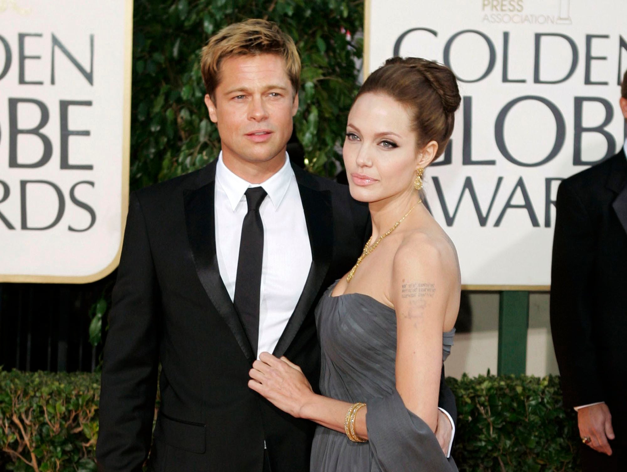 FILE - In this Jan. 15, 2007 file photo, Brad Pitt, and actress Angelina Jolie arrive for the 64th Annual Golden Globe Awards in Beverly Hills, Calif.  The couple have reached a temporary agreement that will allow the actor to visit with his six children, sources familiar with the arrangement told The Associated Press on Friday, Sept. 30, 2016. Jolie Pitt filed for divorce last week.  (AP Photo/Mark J. Terrill, File)