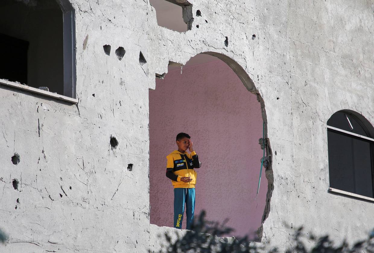 Un niño mira desde un edificio afectado por un ataque israelí en Rafah, en el sur de la Franja de Gaza. 3 mayo 2024. REUTERS/Hatem Khaled