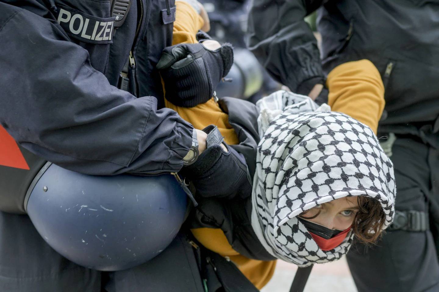 Mujer es retirada po rpolicias en una protesta propalestina del grupo "Coalición Estudiantil Berlin" en el patio de teatro de la Universidad Libre de Berlínm, (Foto AP, Markus Schreiber)