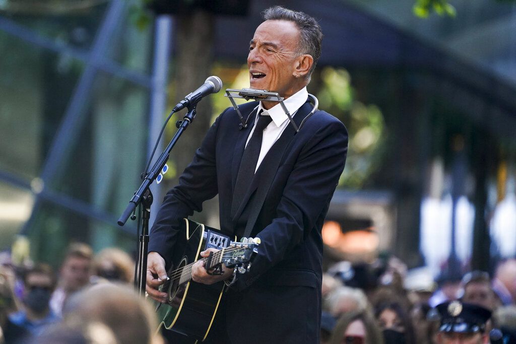 Bruce Springsteen performs during a ceremony marking the 20th anniversary of the Sept. 11, 2001, terrorist attacks at the National September 11 Memorial and Museum in New York, Saturday, Sept. 11, 2021. (AP Photo/Evan Vucci)