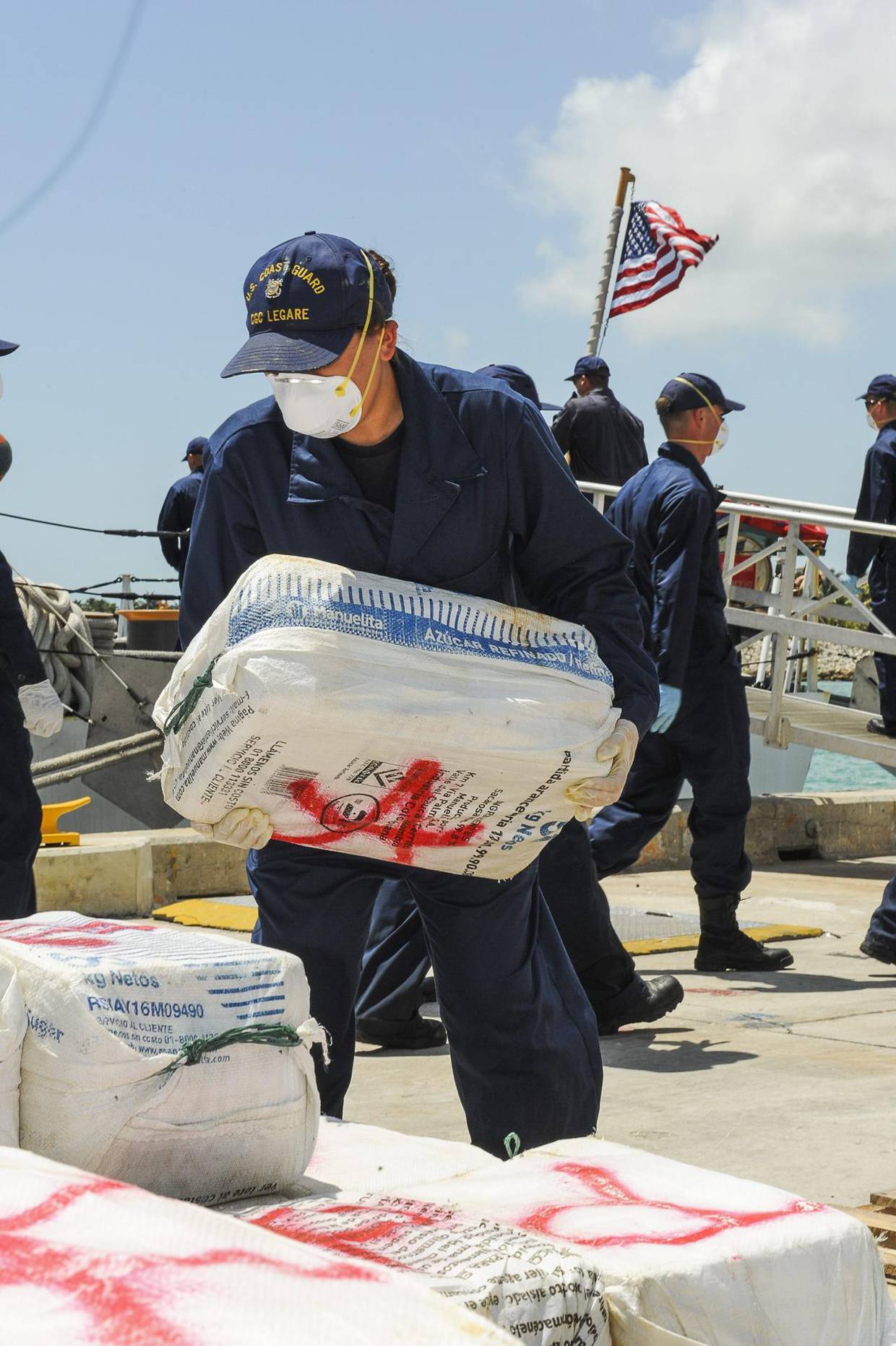 Fotografía de archivo cedida por la Guardia Costera de EE.UU. de un miembro de la tripulación del guarda costas Cutter Legare cargando cocaína decomizada en la base de la guardia costera en Miami, Florida. FE/GUARDIA COSTERA DE EEUU/ARK BARNEY