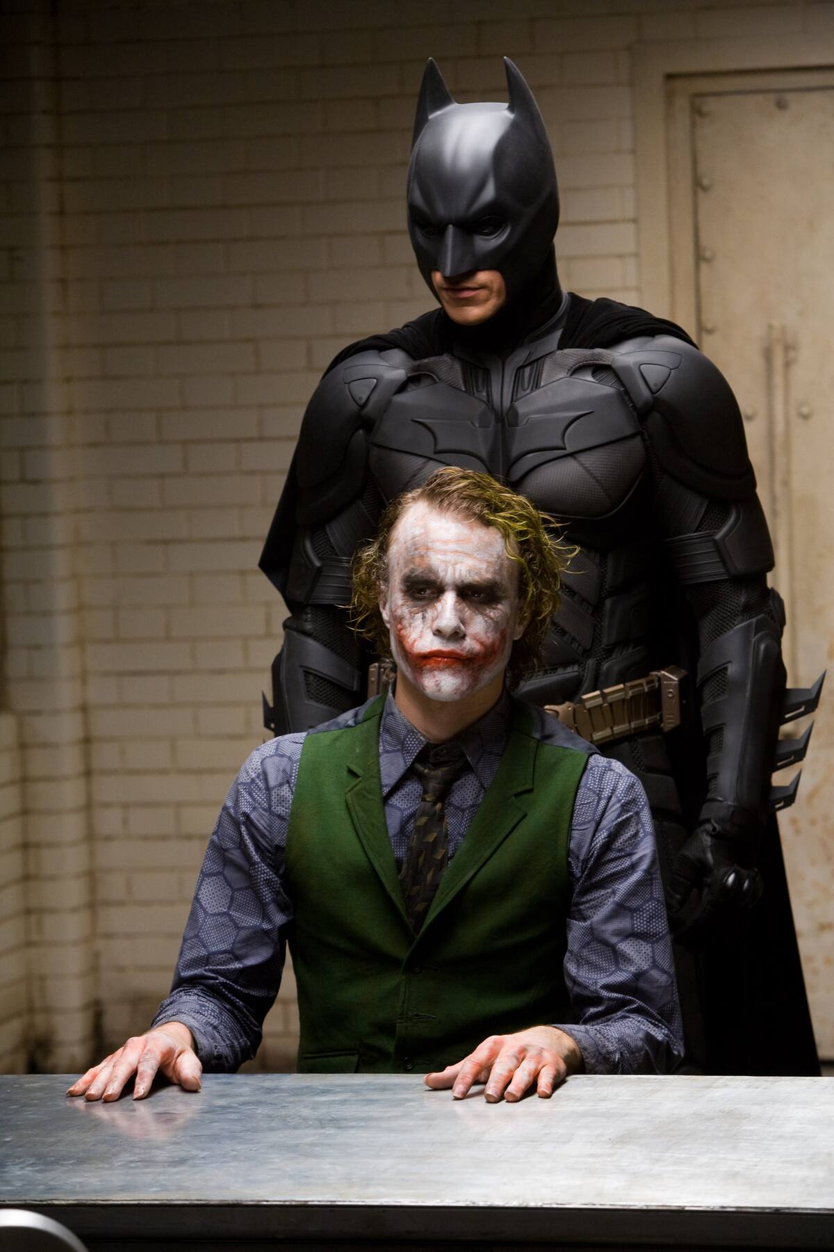 ** FILE ** In this file image originally released by Warner Bros., Heath Ledger starring as The Joker, is shown in a scene with Christian Bale, starring as Batman in "The Dark Knight." . (AP Photo/Warner Bros. Pictures, Stephen Vaughan) ** NO SALES **
