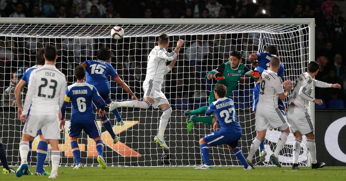 Real Madrids Sergio Ramos, center, heads the ball to score opening goal during the semi final soccer match between Real Madrid and Cruz Azul at the Club World Cup soccer tournament in Marrakech, Morocco, Tuesday, Dec. 16, 2014. (AP Photo/Christophe Ena)