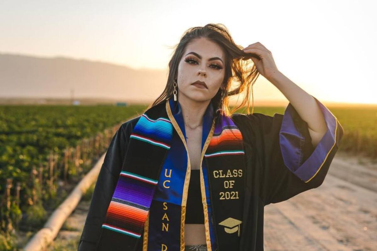 Estudiante honra a sus padres tomando sus fotos de graduación en el campo donde trabajan
