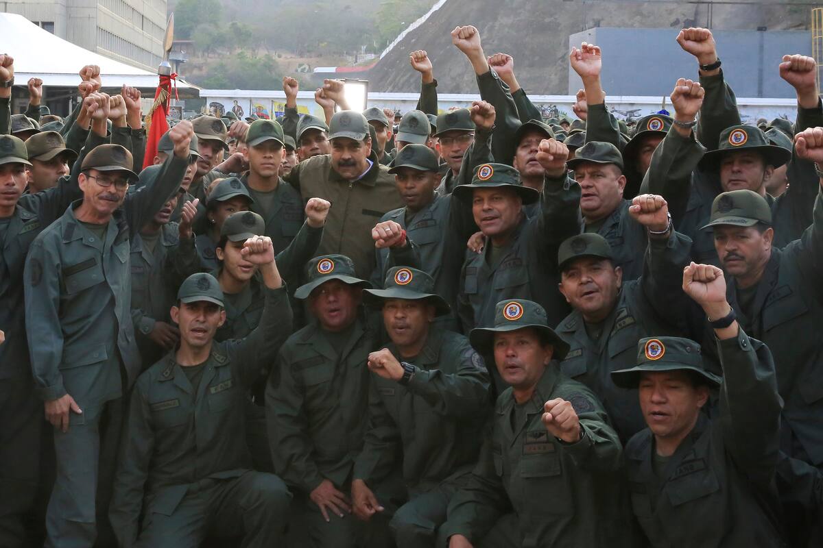 In this photo released by Miraflores Press Office, Venezuela's President Nicolas Maduro, center left, poses for a photo with troops at Fort Tiuna, in Caracas, Venezuela, Thursday, May 2, 2019. Flanked by commanders, Maduro said Thursday that the military must be prepared to combat "traitors", two days after opposition leader Juan Guaidó called for the military to turn against Maduro. (Jhonn Zerpa/Miraflores Press Office via AP)