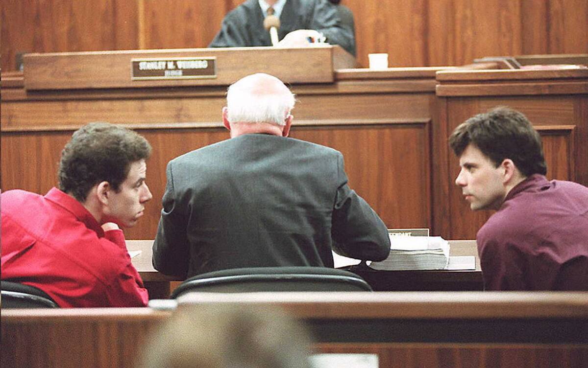 LOS ANGELES, UNITED STATES: This 02 February 1995 file photo shows Erik (L) and Lyle (R) Menendez talking in a Los Angeles courtroom. The brothers were convicted by a jury 20 March of murdering their parents. AFP PHOTO (Photo credit should read KIM KULISH/AFP via Getty Images)