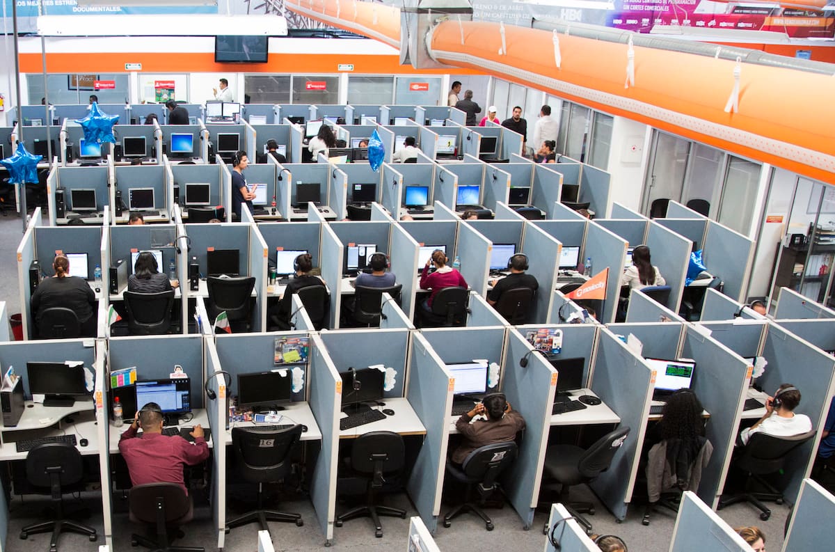 In this Aug. 13, 2014 photo, workers sit at desks at Firstkontact Center, a call center in the northern border city of Tijuana, Mexico. If youre sitting in an office, you should probably read this standing up. In the first advice of its kind, British experts are recommending office workers stand for at least two hours a day, in a warning against the dangers of sitting. The guidelines were developed by a group of experts invited by Public Health England and an advocacy group and were published online Monday, June 1, 2015 in the British Journal of Sports Medicine. (AP Photo/Alex Cossio, File)