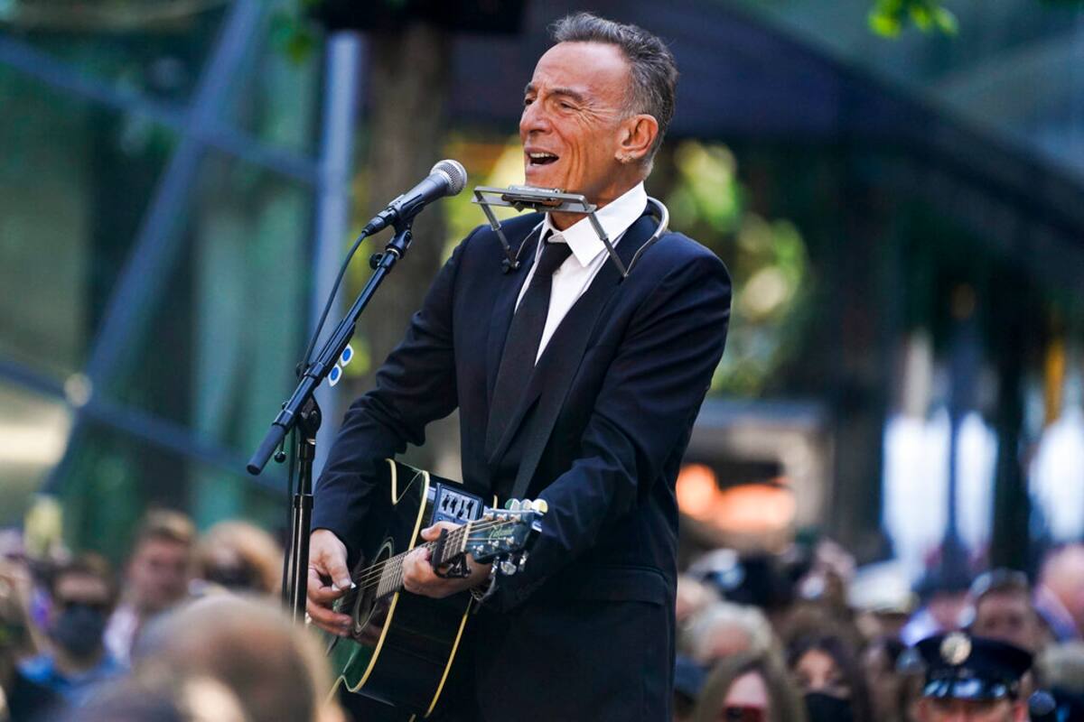 Bruce Springsteen performs during a ceremony marking the 20th anniversary of the Sept. 11, 2001, terrorist attacks at the National September 11 Memorial and Museum in New York, Saturday, Sept. 11, 2021. (AP Photo/Evan Vucci)