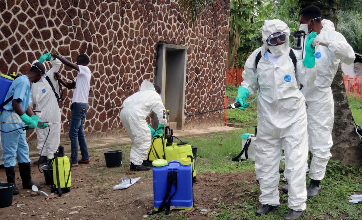 FILE - In this Thursday, May 31, 2018, file photo, Congolese health officials prepare to disinfect people and buildings at the general referral hospital in Mbandaka, Congo. At least four new cases of the Ebola virus have emerged in Congo's northeast, just a week after an outbreak in the northwest was declared over, the country's health ministry said Wednesday. Aug 1, 2018. There was no indication the two outbreaks, separated by more than 2,500 kilometers (1,553 miles), are related, Health Minister Dr. Oly Ilunga Kalenga said in a statement. (AP Photo/John Bompengo, File)