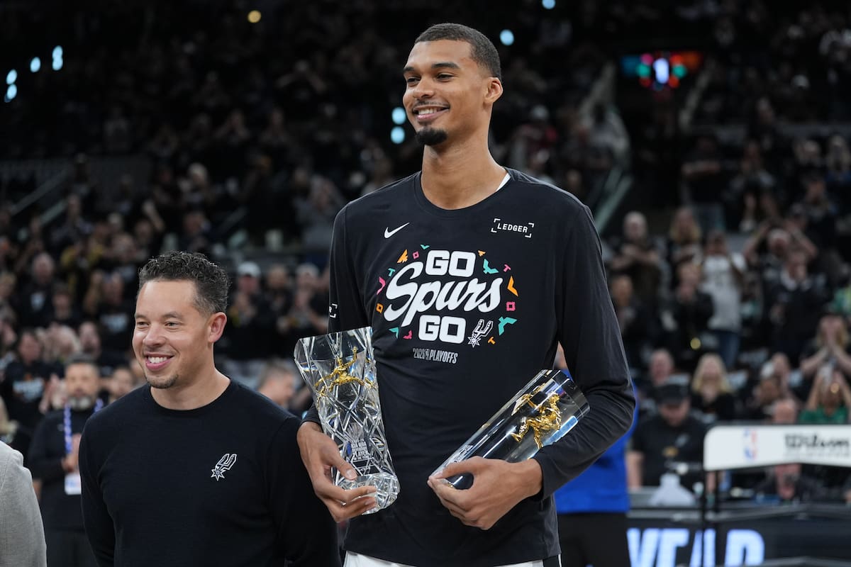 El alero de los Spurs de San Antonio Victor Wembanyama, junto al entrenador Mitch Johnson tras recibir el premio al Defensivo del Año antes del juego 2 de la primera ronda el martes 21 de abril del 2026. (AP Foto/Eric Gay)