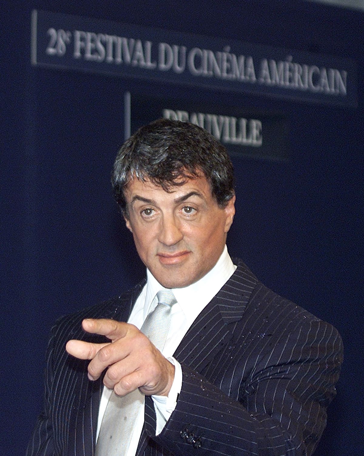 Sylvester Stallone gestures as he poses for photographers at Deauville's American Film Festival to promote the film "Avenging Angelo" directed by Martin Buke, Saturday Sept. 7, 2002, Deauville, France. (AP Photo/Franck Prevel)