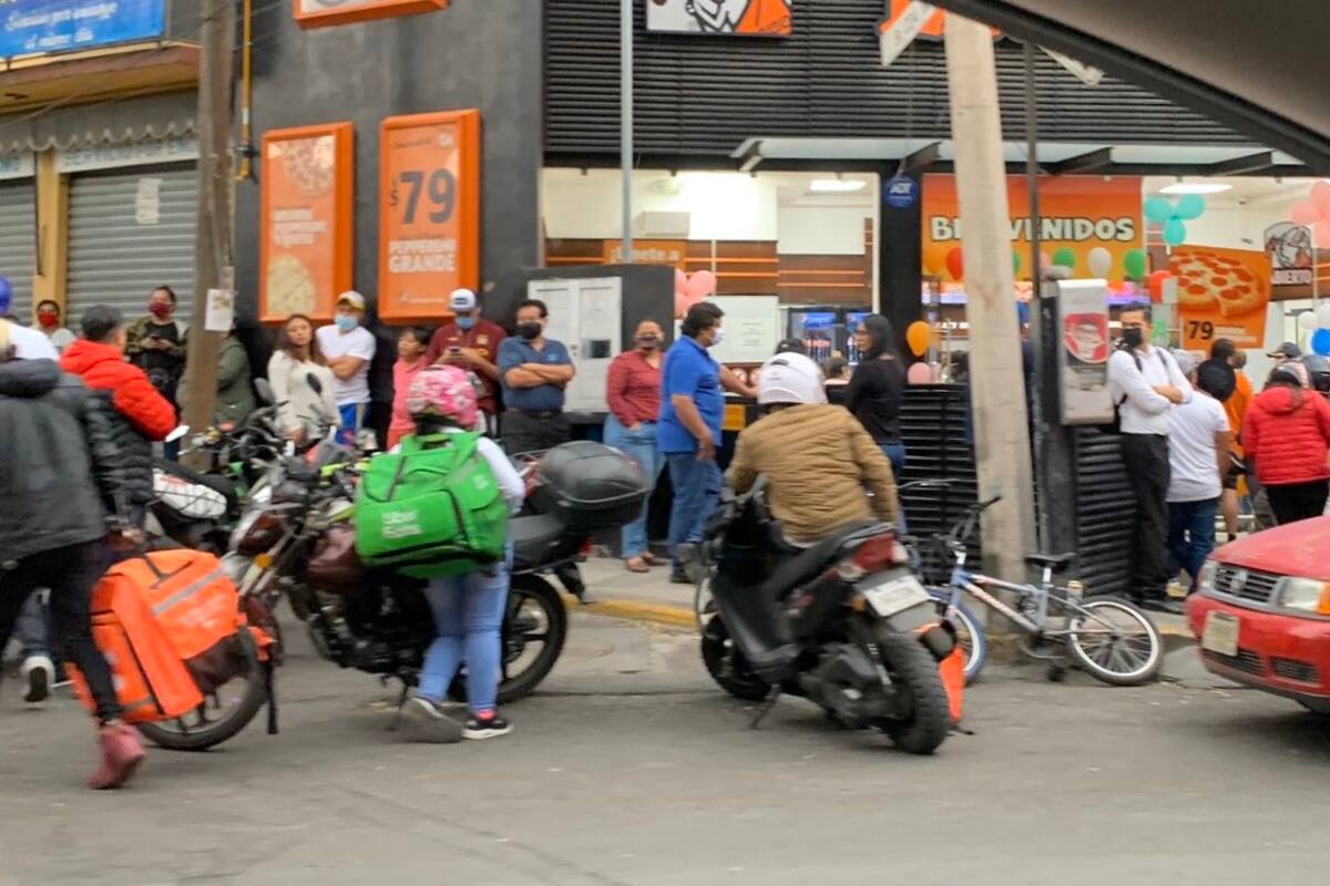 Poblanos retan al COVID-19 y hacen larga fila para comprar pizza