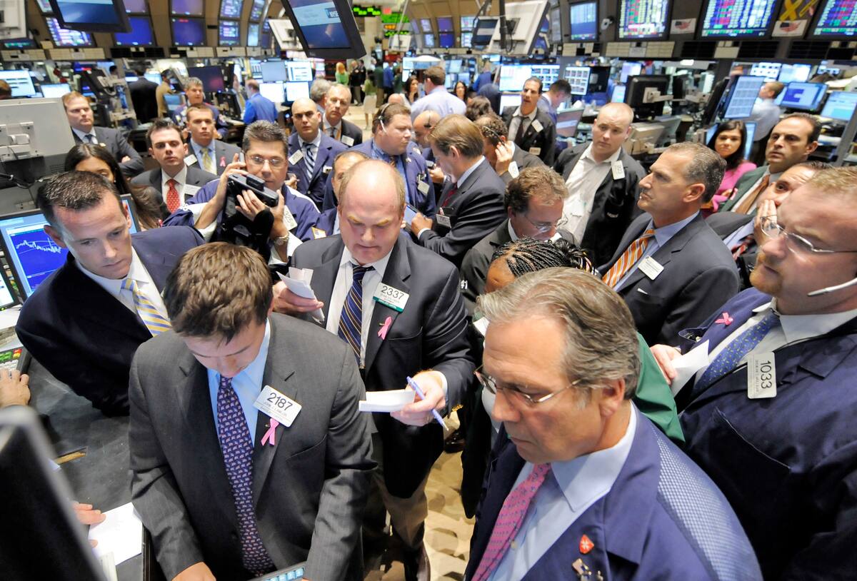 Traders gather at the post that handles Ventas on the floor of the New York Stock Exchange, Friday, Oct. 10, 2008. Wall Street capped its worst week ever with a wild session Friday that saw the Dow Jones industrials rocket within a 1,000 point range before closing with a relatively mild loss and the Nasdaq composite index actually end with a modest advance. (AP Photo/Richard Drew)