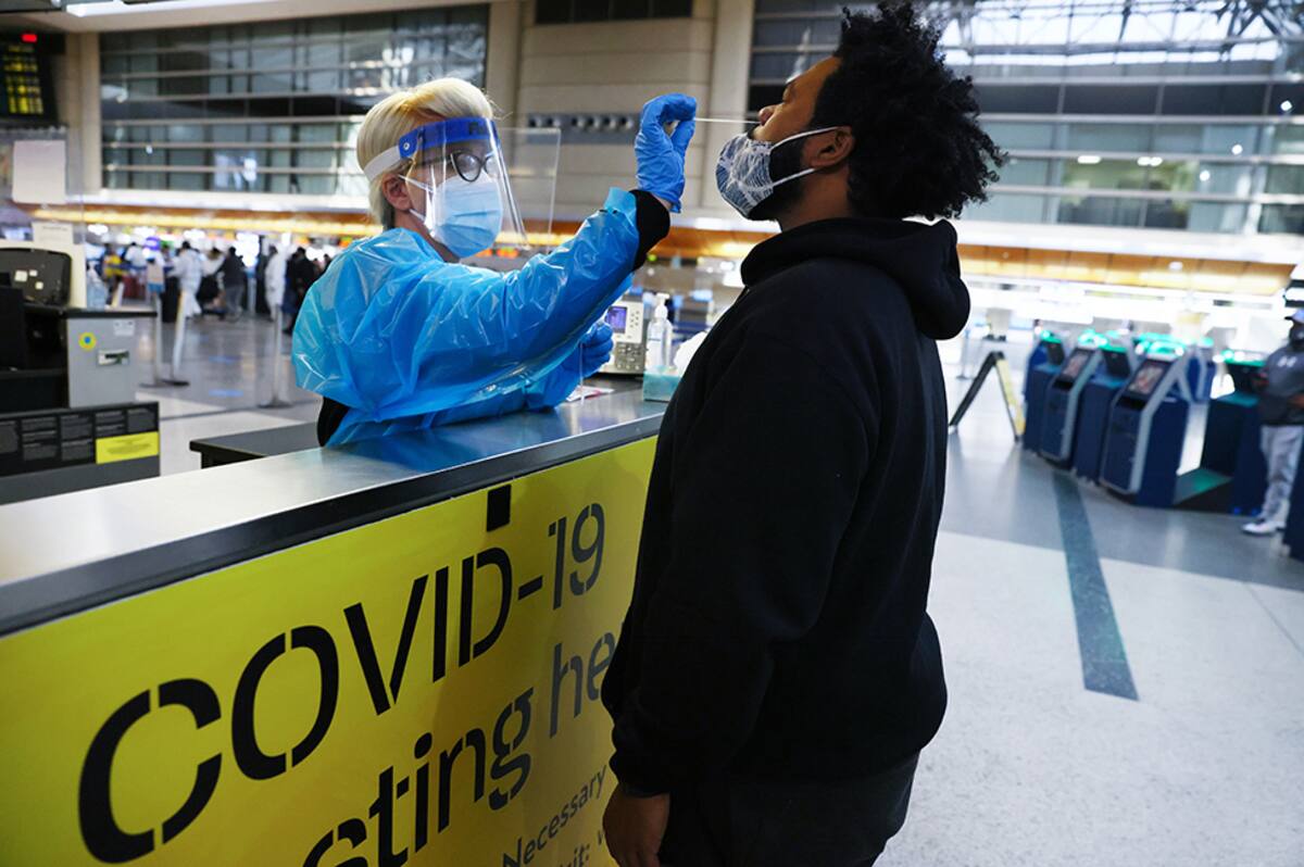 LOS ANGELES, CALIFORNIA - DECEMBER 22: A man receives a nasal swab COVID-19 test at Tom Bradley International Terminal at Los Angeles International Airport (LAX) amid a coronavirus surge in Southern California on December 22, 2020 in Los Angeles, California. The tests are not mandatory with results returned within 24 hours to help travelers avoid quarantining at their destinations. TSA agents screened over 1 million people for three consecutive days last Friday, Saturday and Sunday, the beginning of the traditional holiday travel season, for the first time since the start of the coronavirus pandemic. (Photo by Mario Tama/Getty Images)