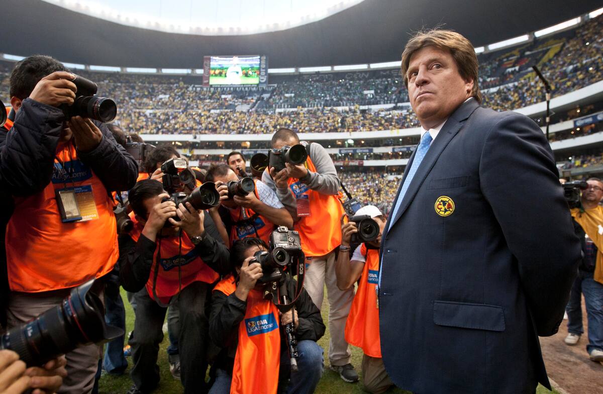 America´s coach Miguel Herrera stands in front of photographers prior to the start of the final match of the Mexican soccer league against Leon in Mexico City, Sunday, Dec.15, 2013. (AP Photo/Christian Palma)