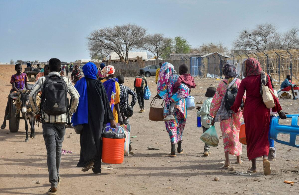 Civilians who fled the war-torn Sudan following the outbreak of fighting between the Sudanese army and the paramilitary Rapid Support Forces (RSF) walk at the Joda South border point, in Renk County, Upper Nile state, South Sudan April 30, 2023. REUTERS/Jok Solomun