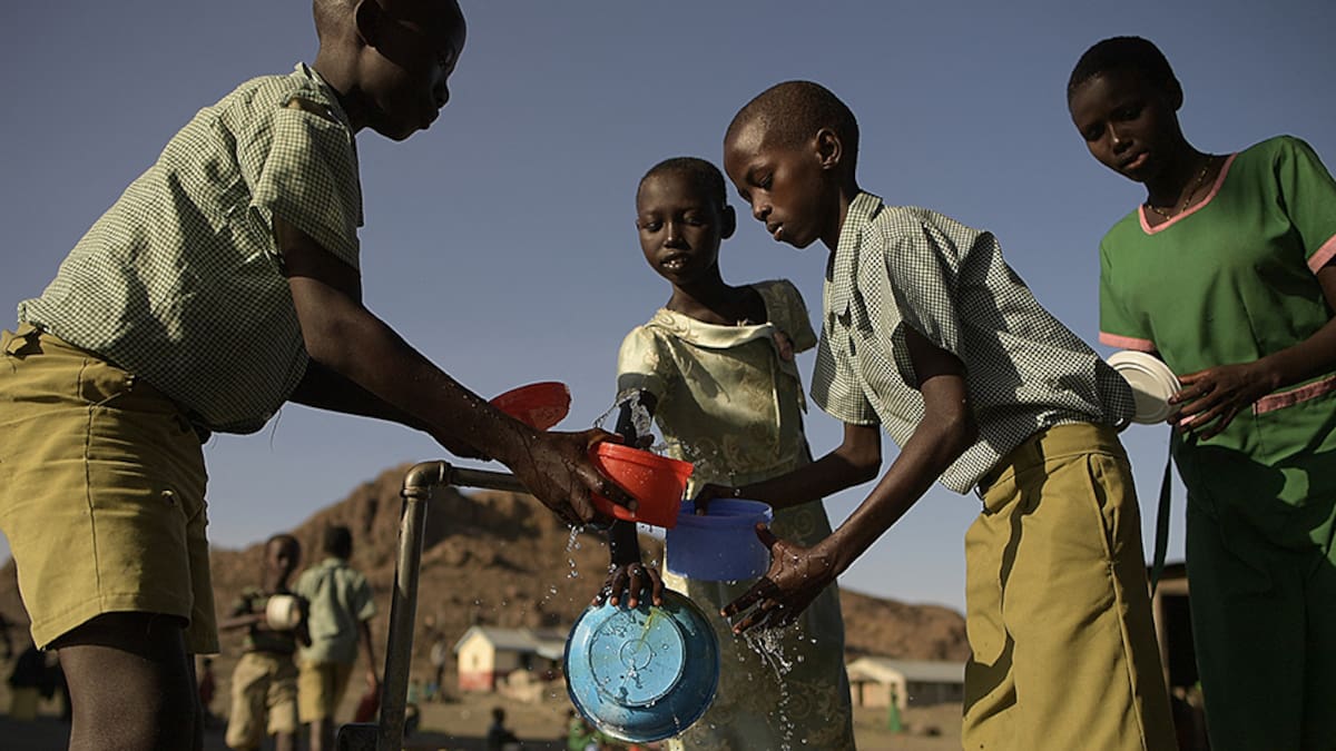 Pupils of El-molo bay primary school rinse their lunch boxes with water from a tap in Loiyangalani, northern Kenya, on July 13, 2022. - At least 18 million people across the Horn of Africa are facing severe hunger as the worst drought in 40 years devastates the region.
Over four million are in Kenya's often-forgotten north, a number that has climbed steadily this year, as the crisis struggles to attract national attention in the midst of a hard-fought -- and expensive -- election campaign. (Photo by Simon MAINA / AFP) (Photo by SIMON MAINA/AFP via Getty Images)