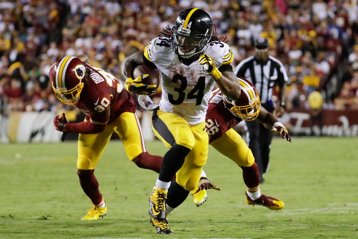 FILE - In this Sept. 12, 2016 file photo, Pittsburgh Steelers running back DeAngelo Williams (34) heads down field after breaking tackles from Washington Redskins defensive back David Bruton (30) and cornerback Bashaud Breeland (26) during the second half of an NFL football game in Landover, Md. (AP Photo/Patrick Semansky, File)