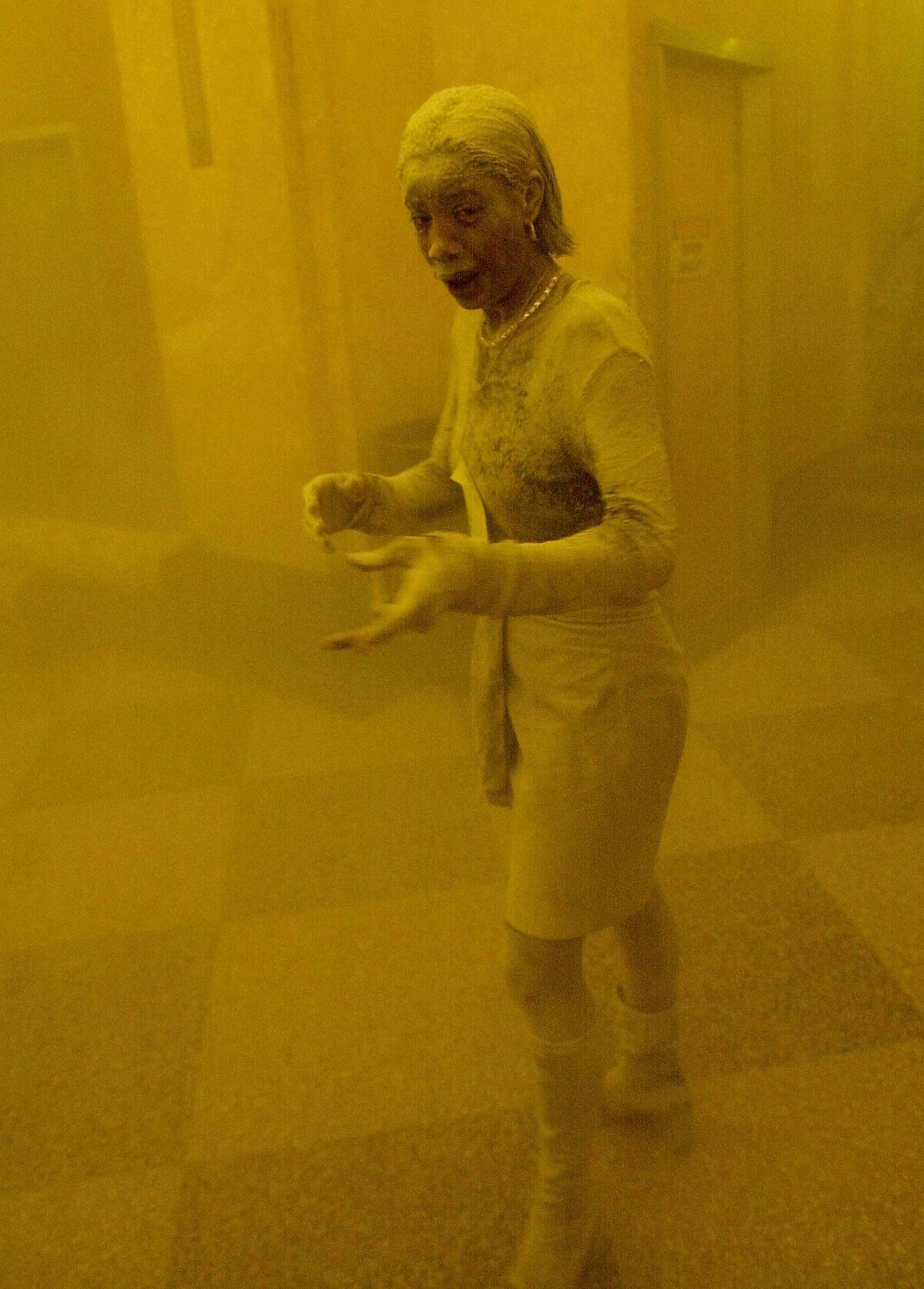 This 11 September 2001 file photo shows Marcy Borders covered in dust as she takes refuge in an office building after one of the World Trade Center towers collapsed in New York. Borders was caught outside on the street as the cloud of smoke and dust enveloped the area. The woman was caught outside on the street as the cloud of smoke and dust enveloped the area. AFP PHOTO/Stan HONDA / AFP / STAN HONDA (Photo credit should read STAN HONDA/AFP/Getty Images)