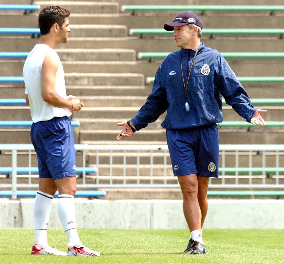 Mexico's national soccer team coach Javier Aguirre, right, talks with Rafael Marquez during a team training session for the 2002 World Cup at Fukui Stadium in Fukui, Japan, Saturday, June 1, 2002. The team is in Group G with, Italy, Ecuador and Croatia. (AP Photo/Walter Astrada)