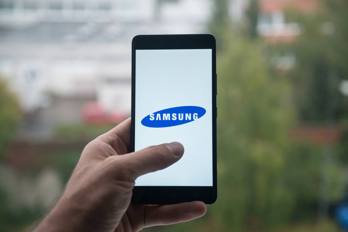 London, United Kingdom, october 3, 2017: Man holding smartphone with Samsung logo with the finger on the screen