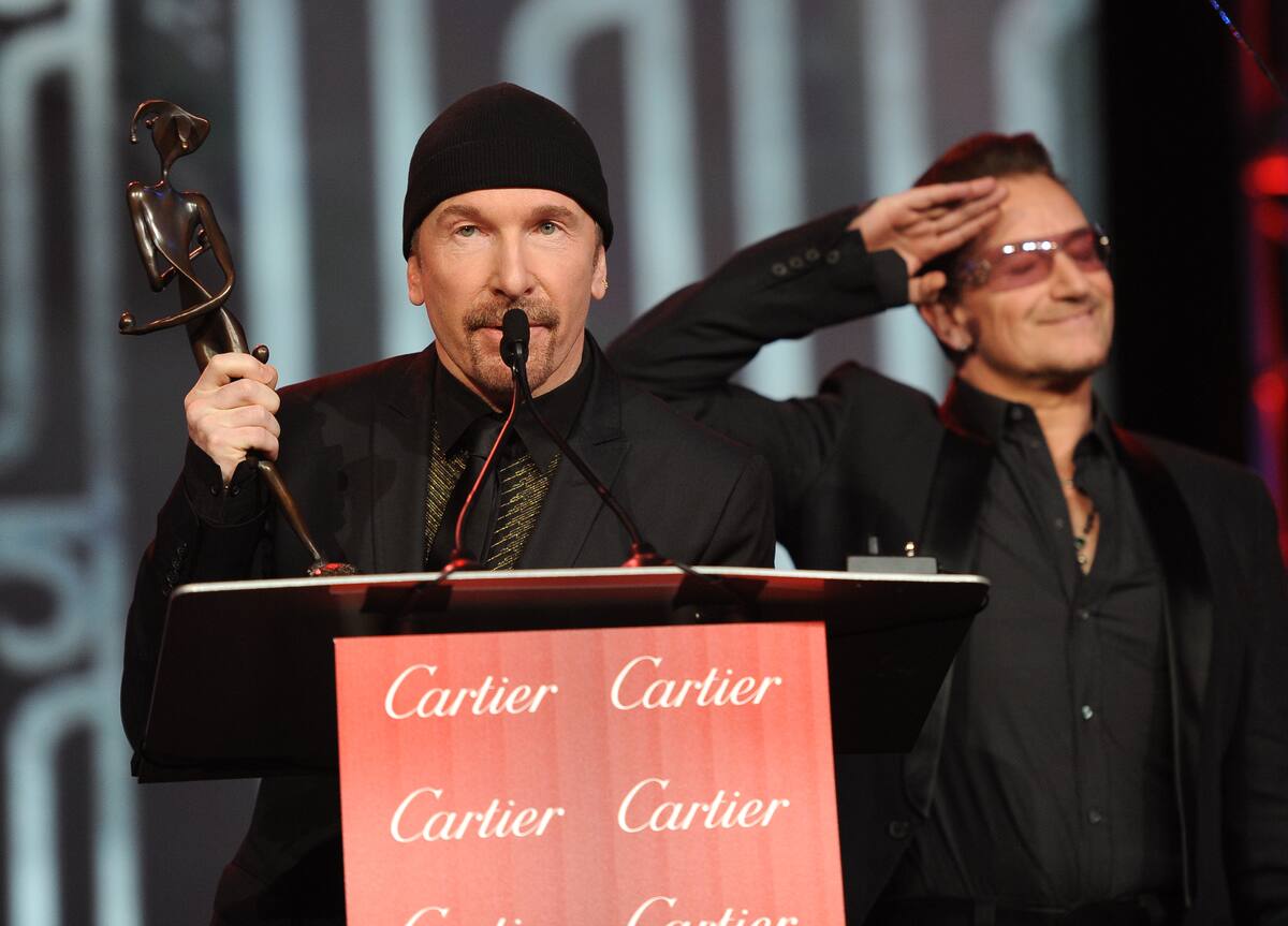 Bono, right, and The Edge, of musical group U2, accept the Sonny Bono Visionary Award at the Palm Springs International Film Festival Awards Gala at the Palm Springs Convention Center on Saturday, Jan. 4, 2014, in Palm Springs, Calif. (Photo by Frank Micelotta/Invision/AP)