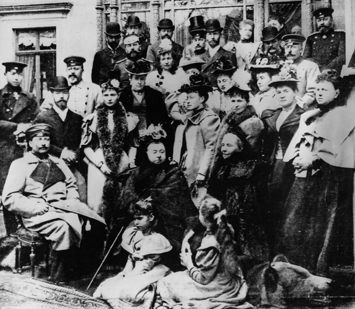 1894: Queen Victoria (1819 - 1901) sits amongst some of her relatives. Amongst them are the Duke of Edinburgh, the Duke of Connaught, Kaiser Wilhelm II (1859 - 1941) (and his mother Victoria) of Germany, the Tsarina of Russia, Prince Edward (1841 - 1910), Tsar Nicholas II (1868 - 1918) of Russia. Most of her children and grandchildren have married into nearly all of the Royal houses of Europe. (Photo by Gunn & Stuart/Hulton Archive/Getty Images)