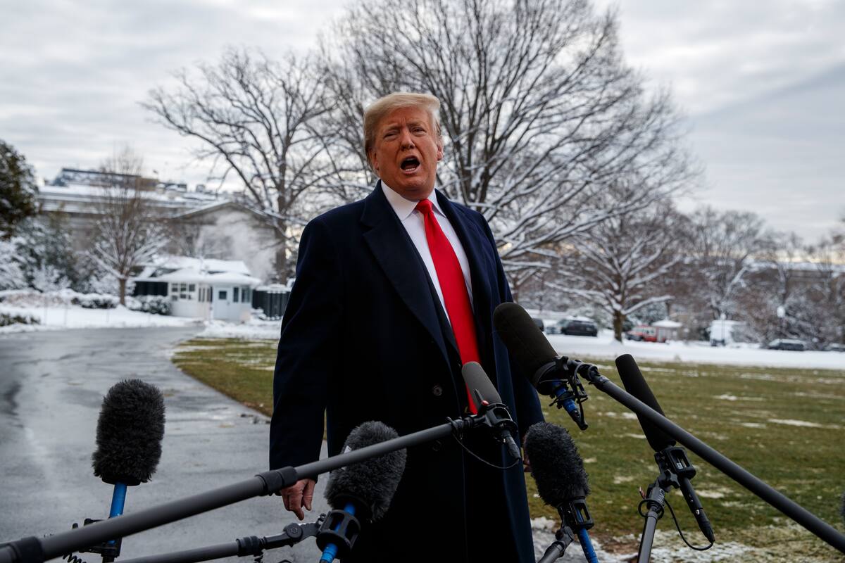 President Donald Trump talks with reporters on the South Lawn of the White House before departing for the American Farm Bureau Federation's 100th Annual Convention in New Orleans, Monday, Jan. 14, 2019, in Washington. (AP Photo/ Evan Vucci)