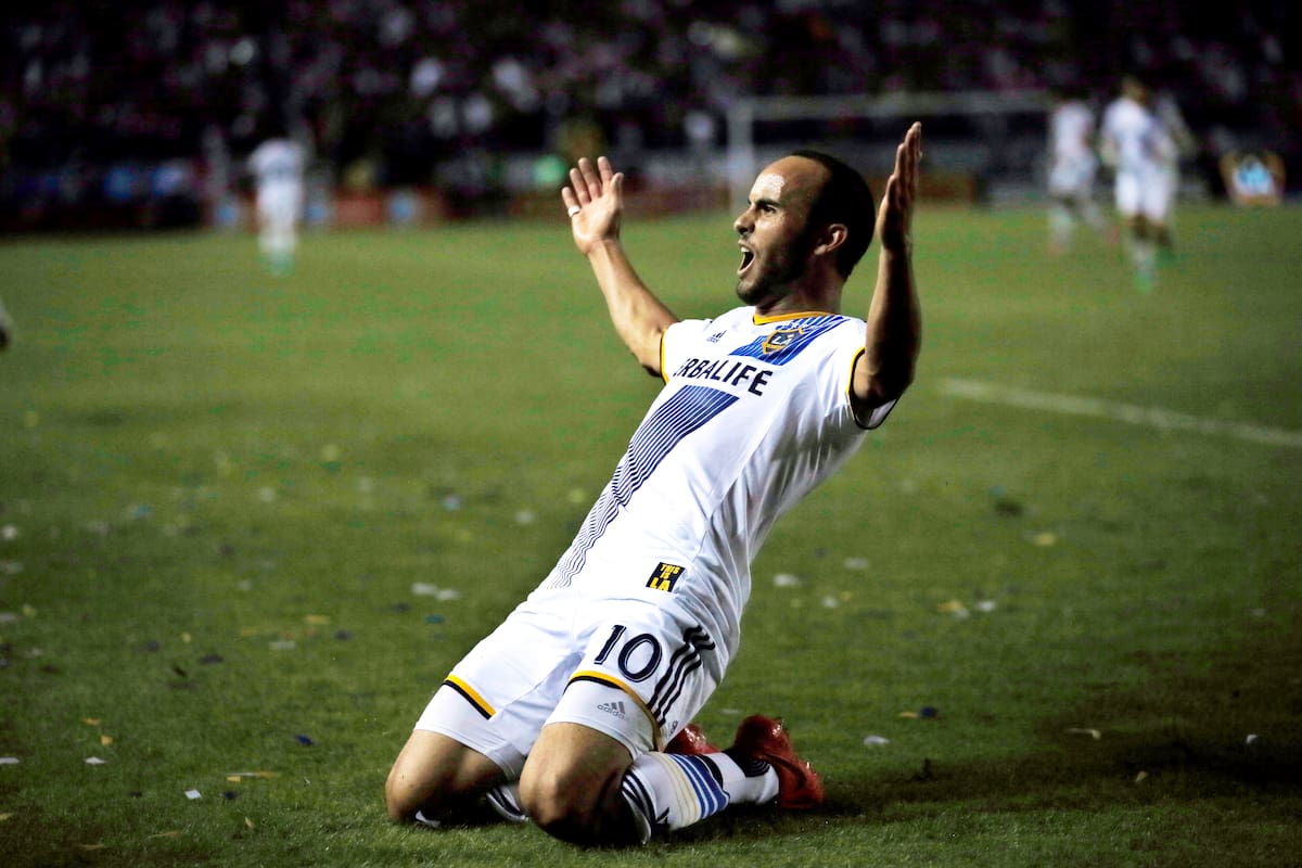 FILE - In this Nov. 9, 2014, file photo, Los Angeles Galaxy's Landon Donovan celebrates scoring a goal against Real Salt Lake during the second half of an MLS soccer Western Conference playoff series game, in Carson, Calif. Although Donovan ends his soccer career in the MLS Cup on Sunday, the LA Galaxy have resisted the notion they're trying to win a title as a parting gift for the greatest player in U.S. history. They've got plenty of motivation against the New England Revolution even without honoring Donovan. (AP Photo/Danny Moloshok, File)
