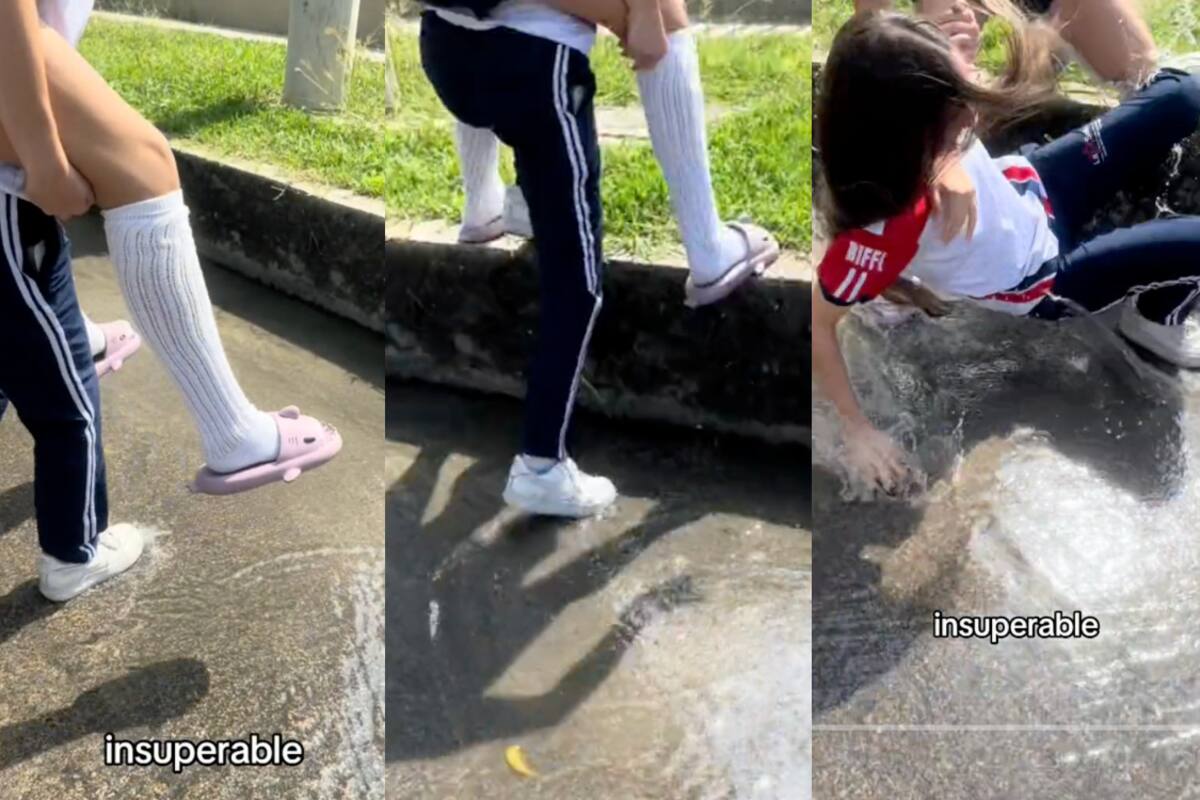 VIDEO | Dos jóvenes intentan cruzar la calle sin mojarse y acaban cayendo en el agua de la alcantarilla