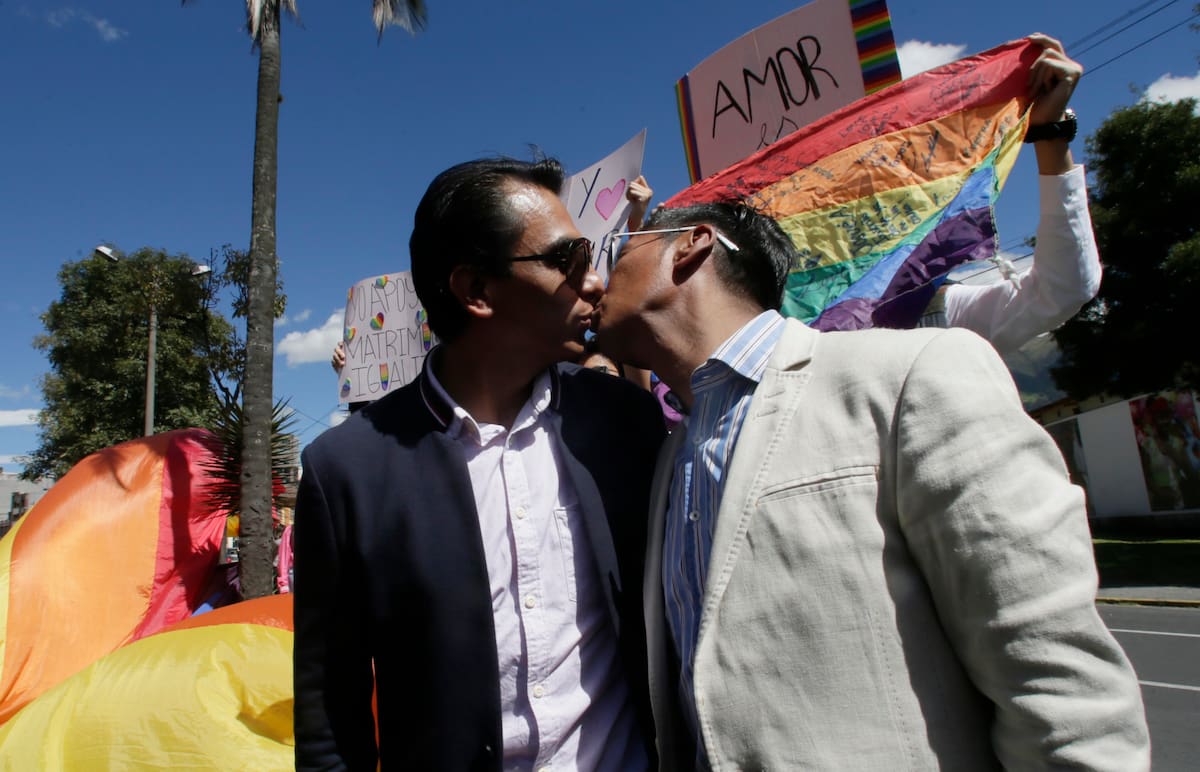 Javier Benalcazar, izquierda, y su pareja Efrain Soria se besan a su llegada a la Corte Constitucional para escuchar la decisión final del organismo sobre matrimonio igualitario en Quito, Ecuador, el martes 4 de junio de 2019. (AP Foto/Dolores Ochoa)