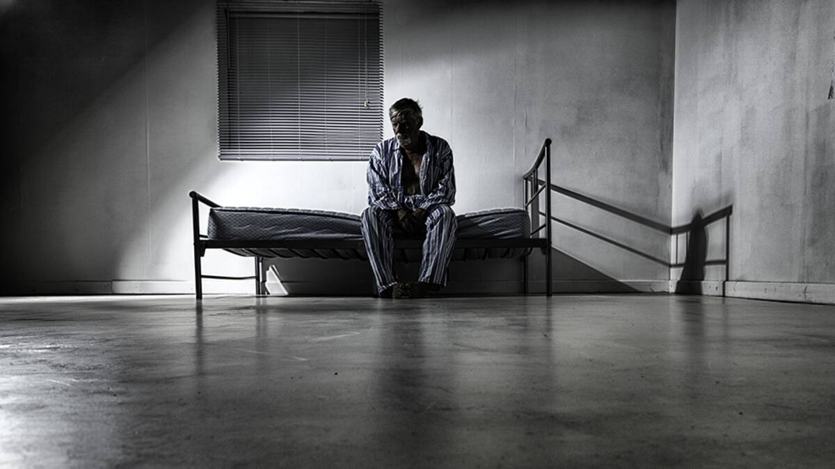 An old man in his 70s incarcerated in a lumatic asylum. Added grain.