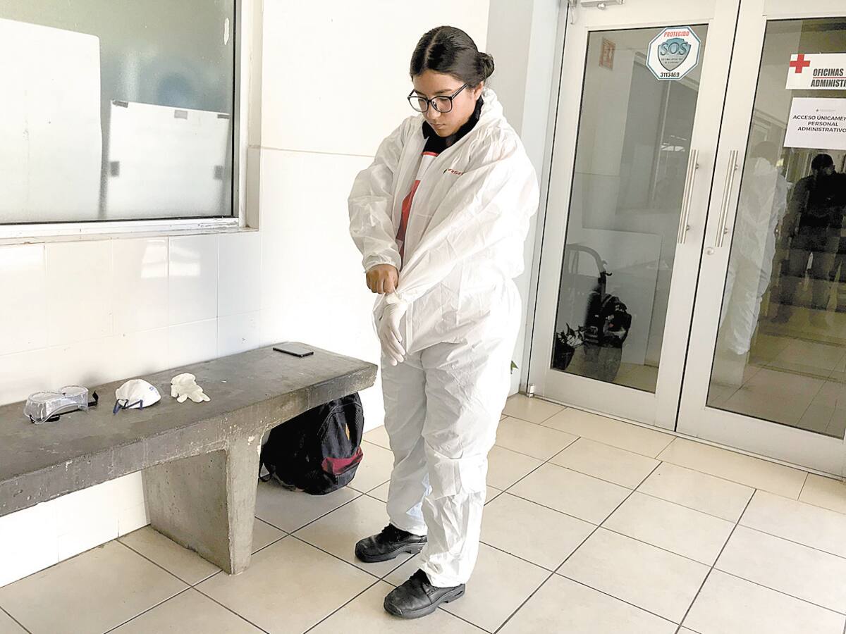 Gisel Sánchez se coloca el traje especial para atender pacientes Covid-19.