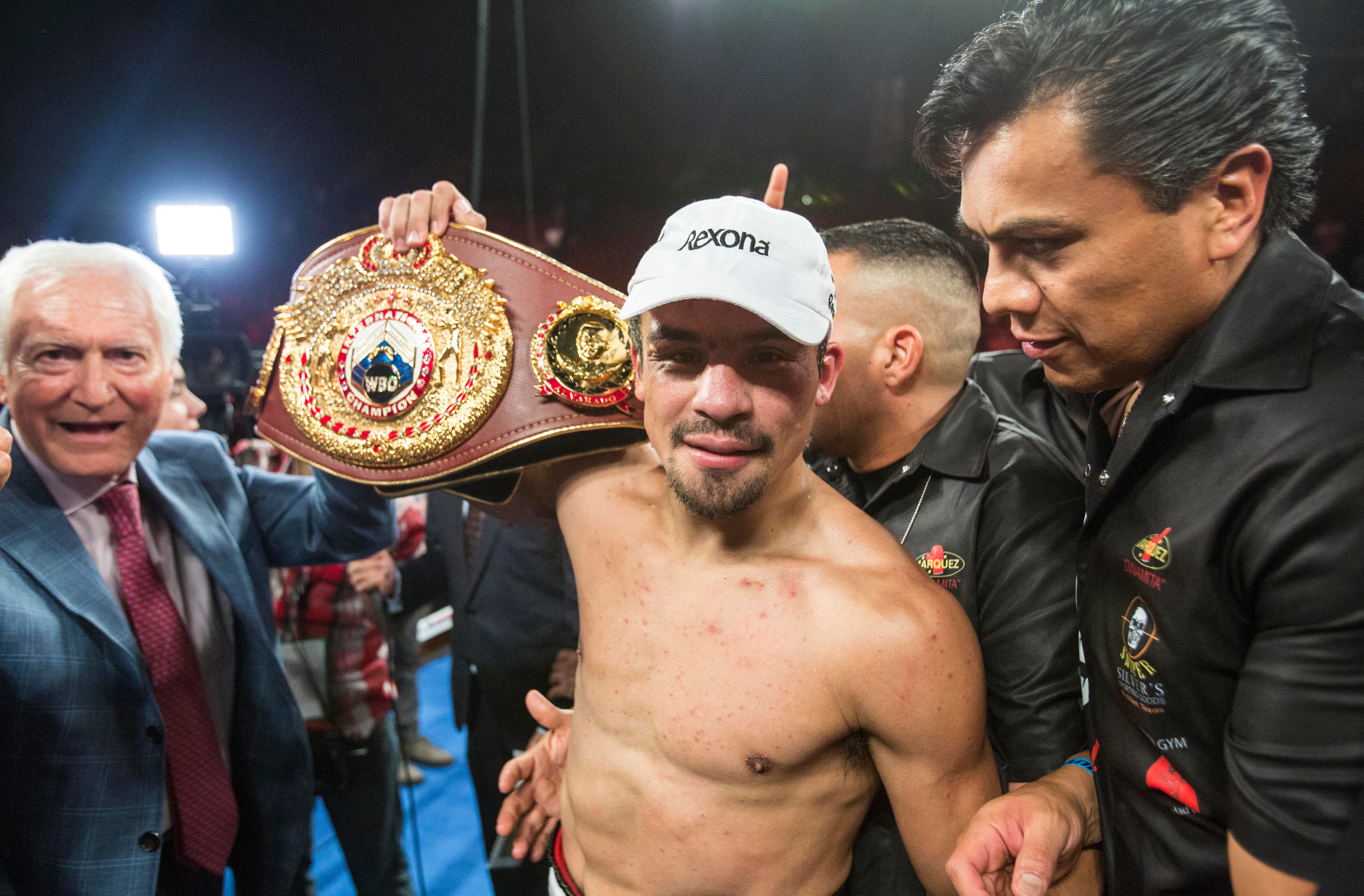 Juan Manuel Márquez, of Mexico, celebrates with championship belt after his victory over Mike Alvarado in the tenth round of a WBO welterweight title boxing match at the Forum in Inglewood, Calif., Saturday, May 17, 2014. (AP Photo/Ringo H.W. Chiu)