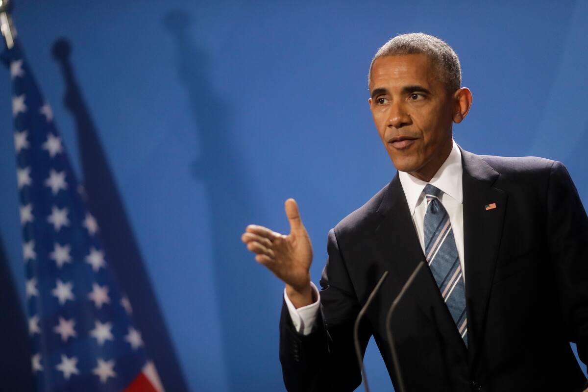 U.S. President Barack Obama attends a news conference with German Chancellor Angela Merkel after a meeting at the chancellery in Berlin, Thursday, Nov. 17, 2016. (AP Photo/Markus Schreiber).