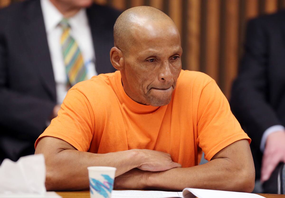 Lewis Taylor listens to Paul D'hedouville, whose father died in the Pioneer Hotel fire in 1970, during a hearing in Pima County Superior Court in Tucson, Ariz. on Tuesday April 2, 2013. Taylor spent more than 40 years in prison for a 1970 hotel fire that killed 29 people agreed to a deal with prosecutors Tuesday that cleared the way for him to be released. The plea deal marks a stunning reversal for Taylor, who was 16 years old when he was arrested in the fire at the Pioneer Hotel in 1970, where employees of an aircraft company were celebrating at a Christmas party. Prosecutors still believe that Taylor is guilty, but said they would not be able to pursue a new trial due to a lack of evidence and living witnesses. (AP Photo/Arizona Daily Star,Benjie Sanders, Pool)