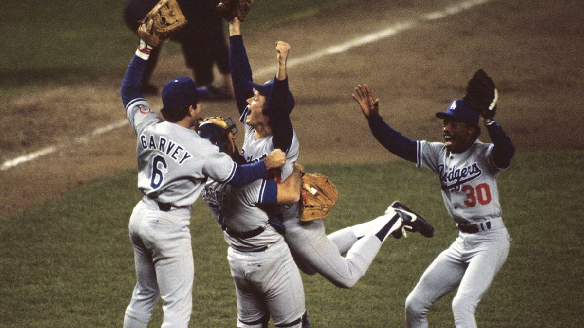 BRONX, NY - OCTOBER 1981: Steve Howe #57 of the Los Angeles Dodgers jumps into the arms of catcher Steve Yeager #7 of the Los Angeles Dodgers with Steve Garvey #6 and Derrel Thomas #30 also of the Los Angeles Dodgers joining the celebration after winning Game 6 of the 1981 World Series against the New York Yankees on October 28, 1981 in the Bronx, New York. (Photo by Ronald C. Modra/Sports Imagery/ Getty Images)