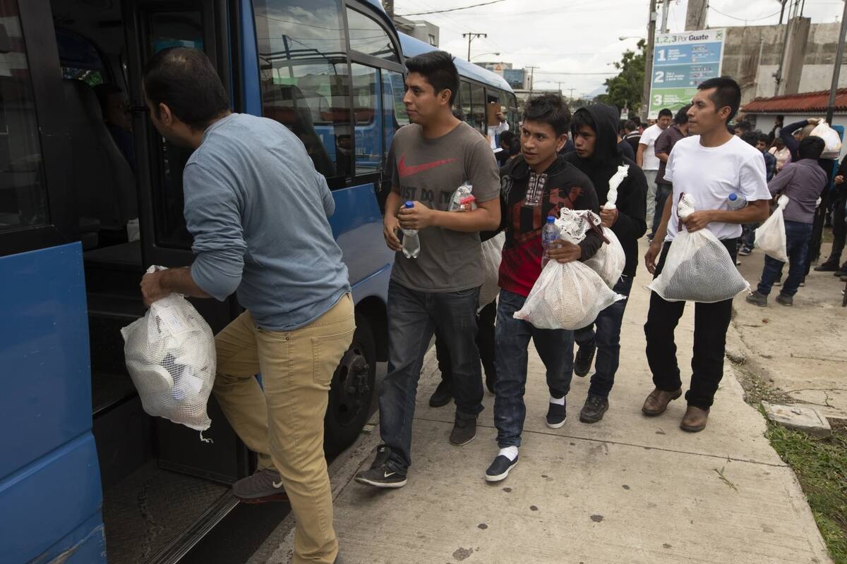 Fotografía de archivo. Migrantes guatemaltecos que fueron deportados de EU abordan autobús para ser devueltos a su país. | Crédito: AP
