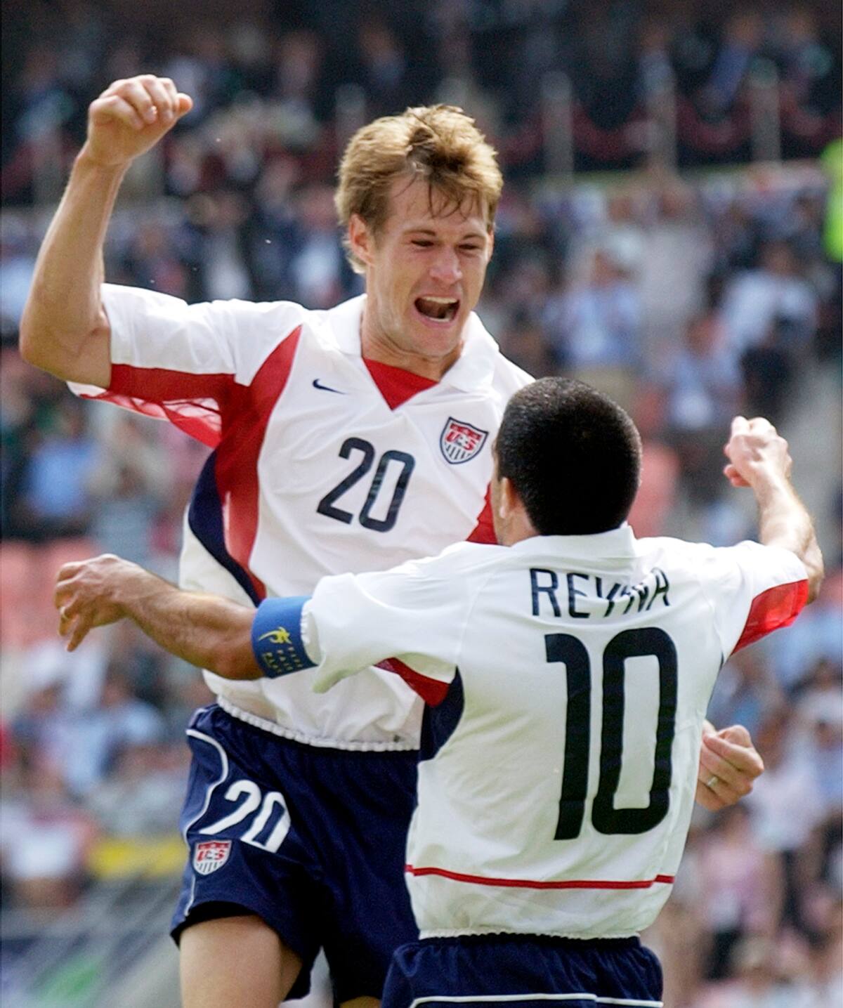 USA's Brian Mc Bride, left, celebrates his goal against Mexico with his teammate Claudio Reyna during their 2002 World Cup second round playoff soccer match at the Jeonju World Cup Stadium at Jeonju, South Korea, Monday, June 17, 2002. (AP Photo/Elise Amendola)