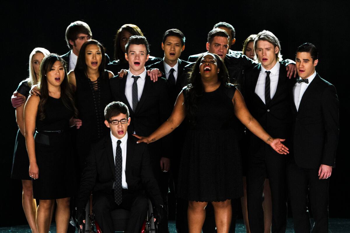 This photo released by Fox shows the McKinley family of the past and present joining together to remember and celebrate the life of Finn Hudson in "The Quarterback" episode of "Glee." The high school musical drama said goodbye to Finn, its beloved singer-quarterback, while paying tribute to Cory Monteith, the late actor who had portrayed him, in a much-anticipated episode that aired Thursday, Oct. 10, 2013. (AP Photo/Fox, Adam Rose)