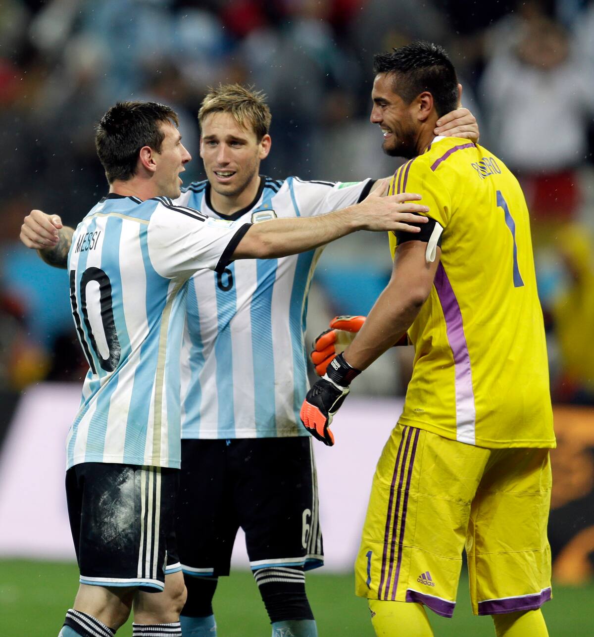 Argentina's Lionel Messi celebrates with Lucas Biglia and goalkeeper Sergio Romero after Argentina defeated the Netherlands 4-2 in a penalty shootout after a 0-0 tie after extra time to advance to the finals during the World Cup semifinal soccer match between the Netherlands and Argentina at the Itaquerao Stadium in Sao Paulo Brazil, Wednesday, July 9, 2014. (AP Photo/Victor R. Caivano)