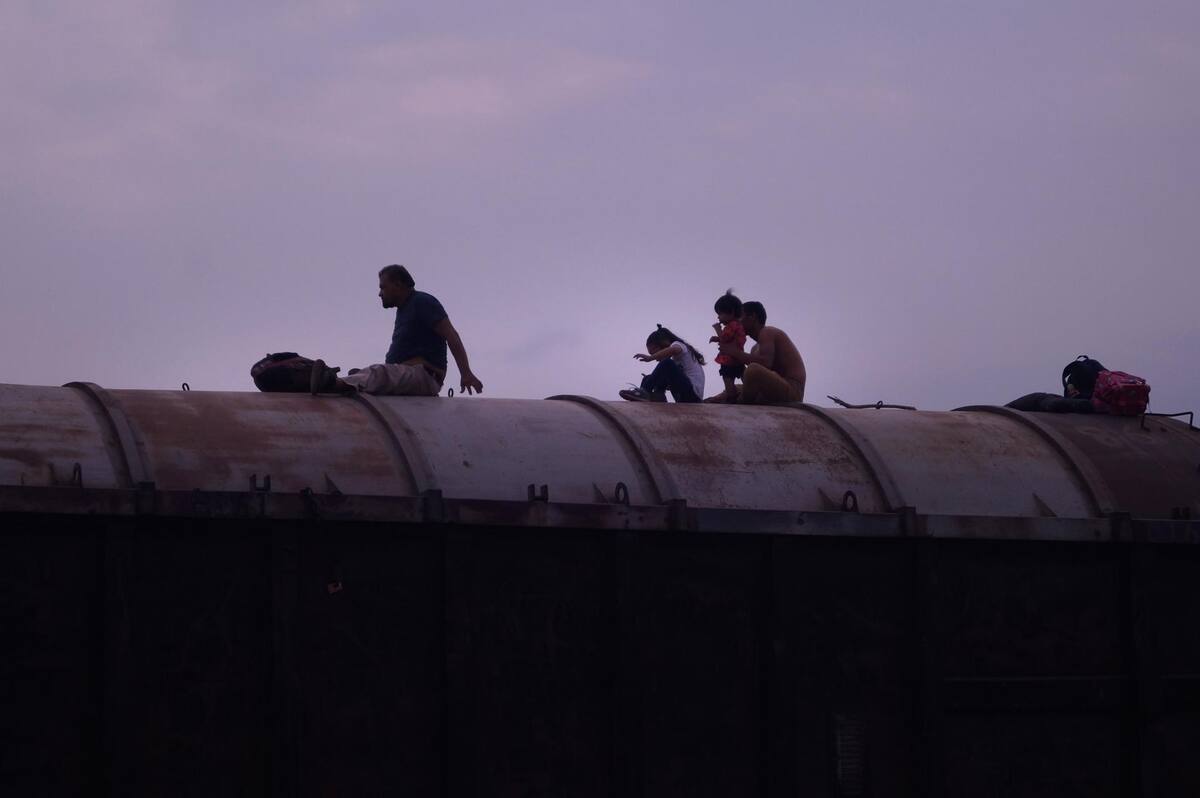 Migrantes centroamericanos descansan sobre las góndolas de un tren de carga. Imagen de archivo. EFE/Carlos López
