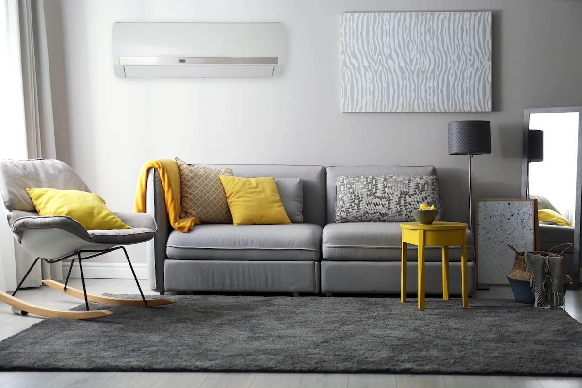 Stylish living room with sofa. Interior design in grey and yellow colors