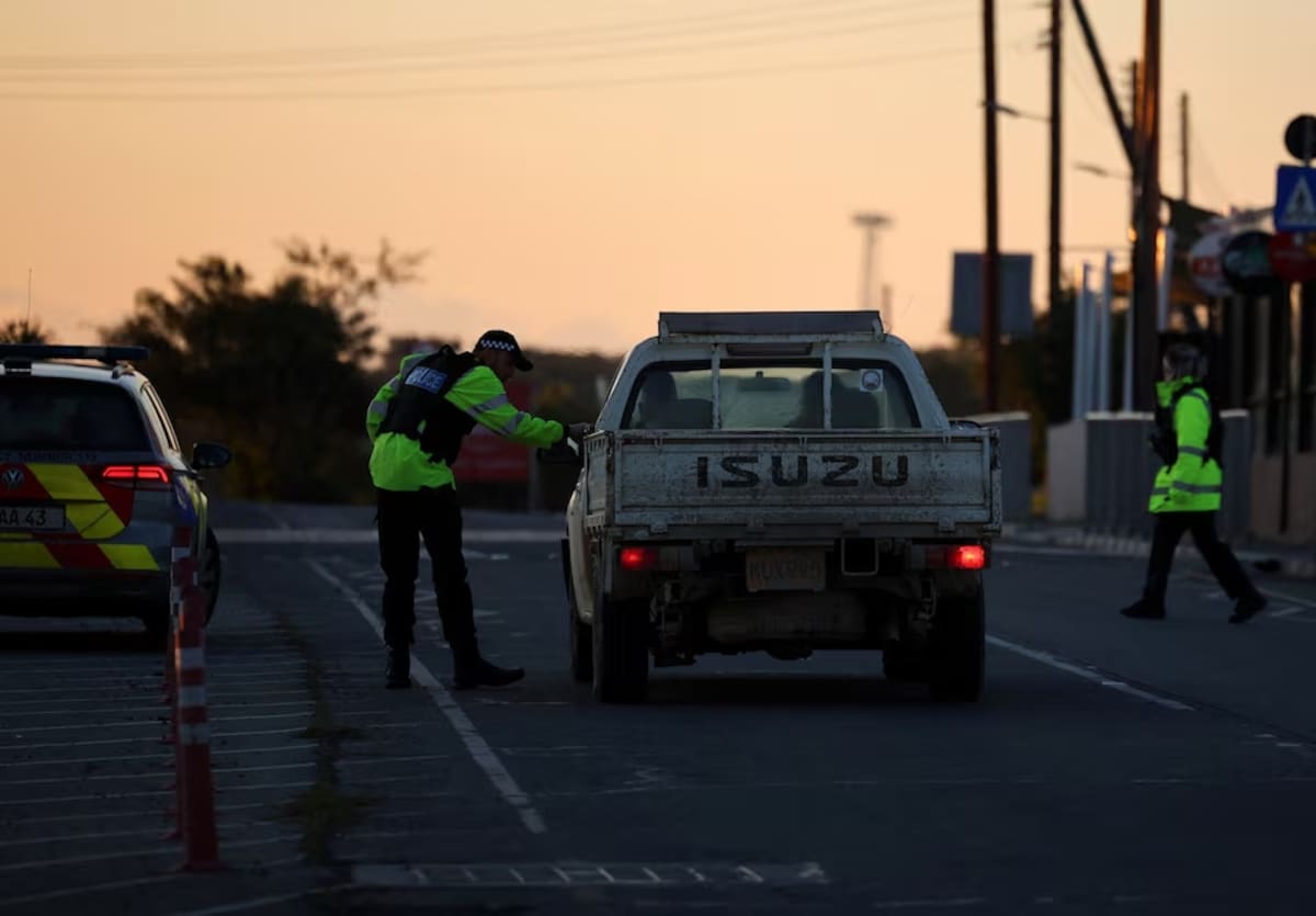 Police check vehicles on the road leading to RAF Akrotiri, a British sovereign base in Cyprus, which was hit by an unmanned drone overnight, causing limited damage, Cyprus March 2, 2026. REUTERS/Yiannis Kourtoglou