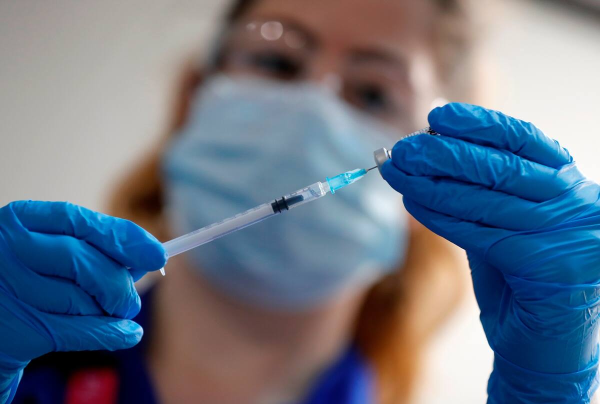 A nurse prepares to administer the Pfizer-BioNTech COVID-19 vaccine at Guy’s Hospital in London, Tuesday, Dec. 8, 2020. U.K. health authorities rolled out the first doses of a widely tested and independently reviewed COVID-19 vaccine Tuesday, starting a global immunization program that is expected to gain momentum as more serums win approval. (AP Photo/Frank Augstein, Pool)