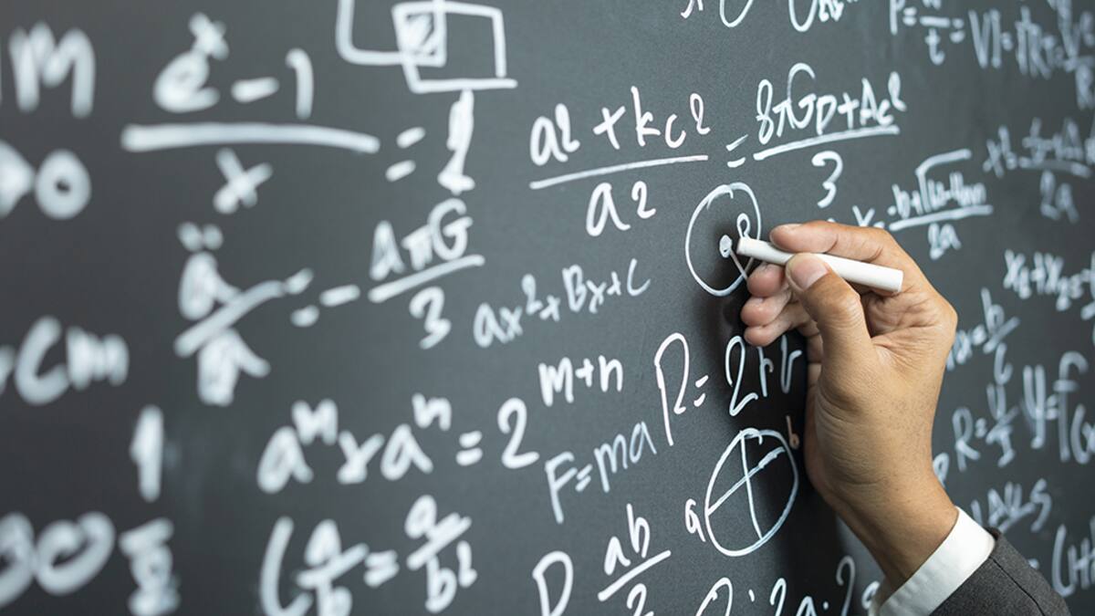 professor writing on the board while having a chalk and blackboard lecture (shallow DOF; color toned image)
