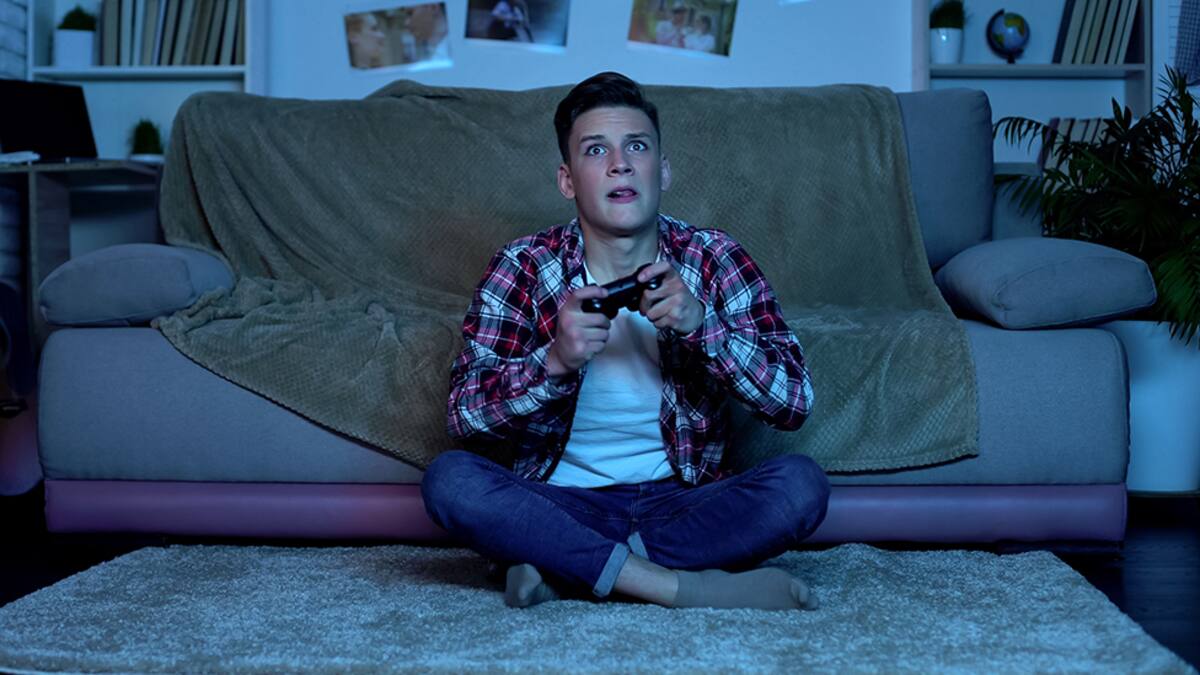 Overemotional teenager plating video game, unstable and uncontrolled emotions