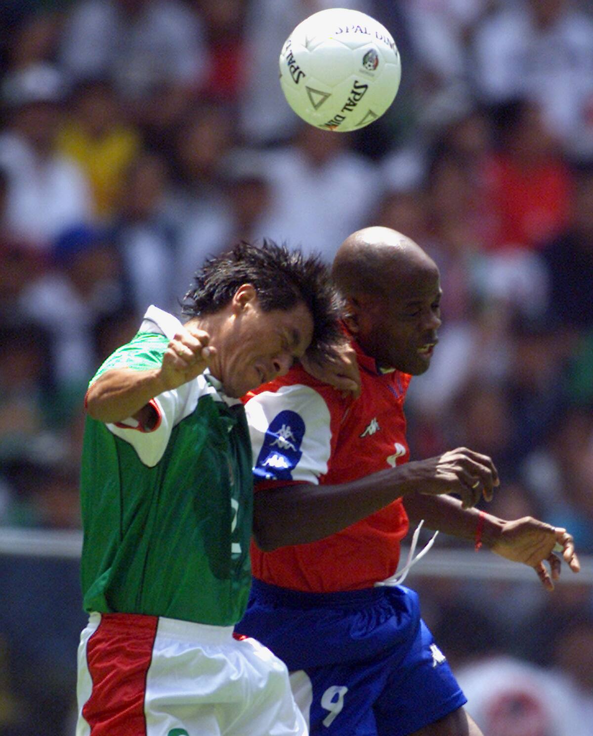 Mexico's Suarez Claudio (L) jumps over Panama's striker Dely Valdez during first half of their 2002 Word Cup qualifying mach in Mexico City's Aztec stadium September 3, 2000. REUTERS/Henry Romero